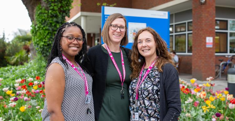 Three Healthwatch staff members standing outside a hospital