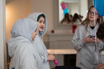 Young girls talking in a classroom