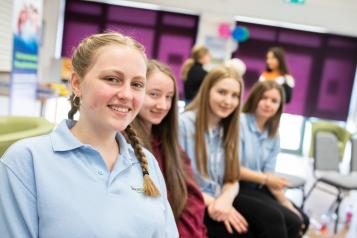 Group of young girls sitting in a row